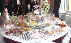 Unique wedding entertainment on a 6' round table sweets buffet silver service